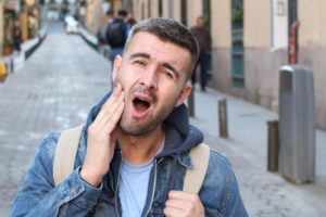 Man holding his jaw in pain restorative dentistry jaw pain dentist in Virginia Beach Virginia